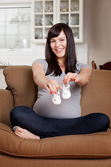 Image showing Pregnant Woman with Baby Shoes