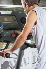 Image showing Man Pressing Program Button on Treadmill