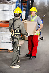 Image showing Foremen Carrying Cardboard Box At Warehouse