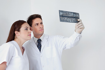 Image showing Doctor And Assistant Analyzing Patient's Report
