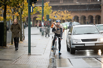 Image showing Male Cyclist Using Walkie-Talkie On Street
