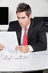 Image showing Businessman Reading Document In Office