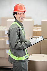 Image showing Supervisor Writing Notes At Warehouse