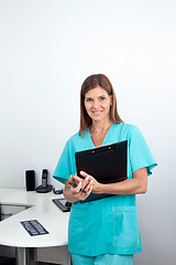 Image showing Female Dentist Holding Clipboard In Clinic