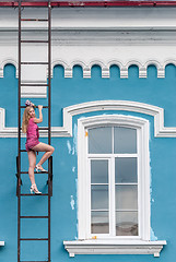 Image showing Pretty woman on fire escape stair