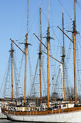 Image showing wooden sailboat mast on blue sky