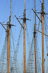 Image showing wooden sailboat mast on blue sky