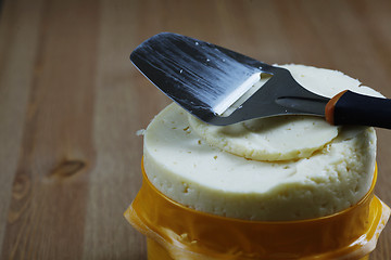 Image showing head cheese and knife on a wooden