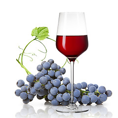 Image showing Glass of red wine and grape isolated on white