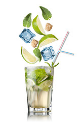 Image showing mohito cocktail with falling ingredients isolated on white