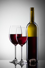 Image showing Wine in glasses and bottle on white