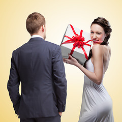 Image showing Man looking on smiling woman holding gift