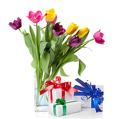 Image showing Color tulips and presents isolated on white