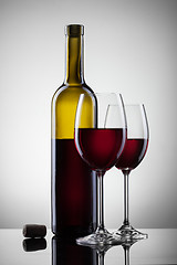 Image showing Wine in glasses and bottle on white