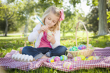 Image showing Cute Young Girl Coloring Her Easter Eggs with Paint Brush