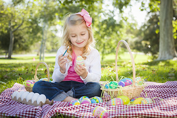 Image showing Cute Young Girl Coloring Her Easter Eggs with Paint Brush