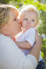 Image showing Young Mother Kissing and Holding Her Adorable Baby Boy