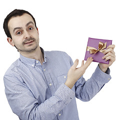 Image showing Young man holding a present