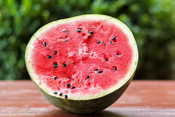 Image showing Fresh juicy watermelon against natural green background