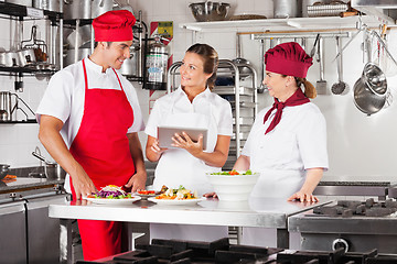 Image showing Chefs Using Tablet Computer At Kitchen Counter