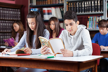 Image showing Male And Female Friend Studying In Library