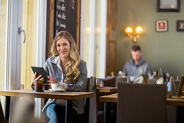 Image showing Pregnant Woman With Digital Tablet At Table