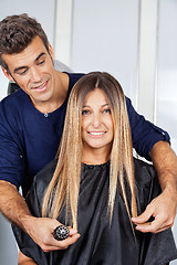 Image showing Woman With Hairdresser Measuring Her Hair At Salon