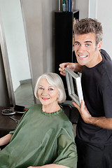 Image showing Customer With Hairdresser Holding Mirror