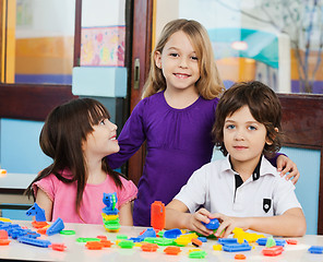 Image showing Girl With Friends Playing Blocks In Classroom