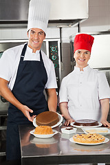 Image showing Happy Chefs With Variety Of Sweet Dishes