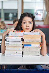 Image showing Angry Schoolgirl Resting Chin On Books