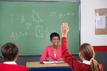 Image showing Teenage Girl Raising Hand While Teacher Looking At Her