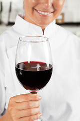 Image showing Female Chef Holding Wine Glass