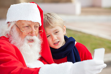 Image showing Santa Claus And Boy Taking Selfportrait Through Smartphone