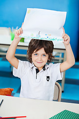 Image showing Boy Showing Drawing Paper In Classroom