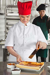 Image showing Chef Preparing Chocolate Roll