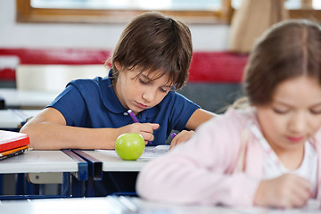 Image showing Schoolboy Drawing In Classroom