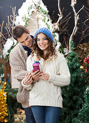 Image showing Woman Holding Christmas Present With Man At Store