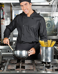 Image showing Happy Chef Preparing Pasta