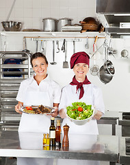 Image showing Female Chefs With Dishes At Kitchen Counter