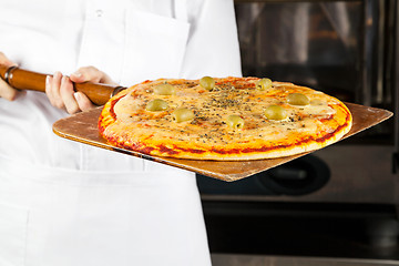 Image showing Chef Holding Pizza On Shovel