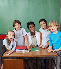 Image showing Happy Female Professor With Students At Desk