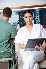 Image showing Female Medical Technician Holding Clipboard