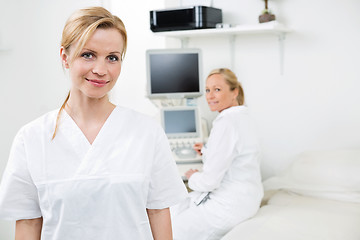 Image showing Happy Female Gynecologist With Colleague In Background