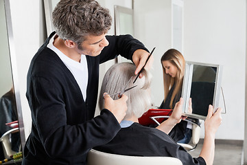 Image showing Hairdresser Cutting Client's Hair At Salon