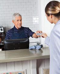 Image showing Customer Giving Credit Card To Cashier At Store