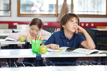 Image showing Young Boy Looking Up In Classroom