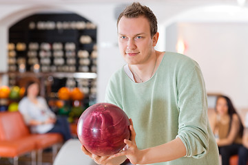 Image showing Man Holding Bowling Ball in Club