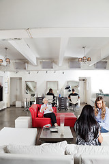 Image showing Client Having Manicure With People Waiting In Salon