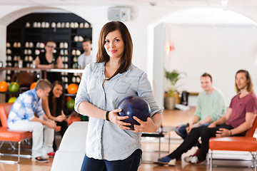 Image showing Confident Young Woman With Bowling Ball in Club